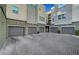 Row of gray garages with sleek doors and brick driveway, adding curb appeal to the condos at 11250 Hidden Peak Ave # 208, Las Vegas, NV 89135