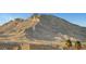 Mountain view from neighborhood rooftop, featuring nearby homes with desert landscape in the background at 11250 Hidden Peak Ave # 208, Las Vegas, NV 89135