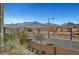 Scenic street view featuring a brick retaining wall with neighborhood and mountain views at 11250 Hidden Peak Ave # 208, Las Vegas, NV 89135