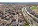 Birds-eye perspective reveals a residential development with a road bisecting the symmetrical layout of homes at 11518 Belmont Lake Dr # 104, Las Vegas, NV 89135