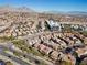 Expansive aerial view of a residential community featuring well-maintained homes and scenic mountain views at 11518 Belmont Lake Dr # 104, Las Vegas, NV 89135