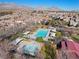 Aerial view displays a community pool area featuring a large pool, hot tub, and ample lounge seating at 11518 Belmont Lake Dr # 104, Las Vegas, NV 89135