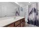 This bathroom features a large mirror, a stylish sink, and a shower with a patterned curtain at 11518 Belmont Lake Dr # 104, Las Vegas, NV 89135