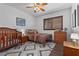 Brightly lit bedroom featuring two beds, wood-look flooring, and neutral-colored walls at 11518 Belmont Lake Dr # 104, Las Vegas, NV 89135