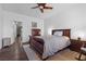 This primary bedroom features a dark wood sleigh bed, ceiling fan, and hardwood floors at 11518 Belmont Lake Dr # 104, Las Vegas, NV 89135