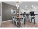 The Dining Room overlooks the Kitchen, featuring stainless steel appliances and herringbone wood flooring at 11518 Belmont Lake Dr # 104, Las Vegas, NV 89135