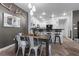 The Dining Room offers a view of the Kitchen with a breakfast bar, complemented by modern decor and herringbone wood flooring at 11518 Belmont Lake Dr # 104, Las Vegas, NV 89135