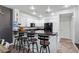 This kitchen has a breakfast bar with seating, stainless steel appliances, and herringbone wood flooring at 11518 Belmont Lake Dr # 104, Las Vegas, NV 89135