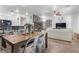 Open concept living room with dining area, seamlessly flowing from the kitchen's breakfast bar with herringbone wood flooring at 11518 Belmont Lake Dr # 104, Las Vegas, NV 89135