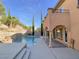 Backyard oasis featuring a sparkling pool, lush trees, and a patio at 12048 La Palmera Ave, Las Vegas, NV 89138