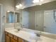 Bright bathroom featuring double sink vanity, a large mirror, and neutral color palette at 12048 La Palmera Ave, Las Vegas, NV 89138