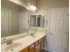 Bright bathroom featuring double sink vanity, a large mirror, and neutral color palette at 12048 La Palmera Ave, Las Vegas, NV 89138