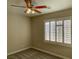 Neutral bedroom showcasing window with shutters and ceiling fan with light at 12048 La Palmera Ave, Las Vegas, NV 89138