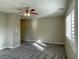 A carpeted bedroom with shuttered windows and a ceiling fan at 12048 La Palmera Ave, Las Vegas, NV 89138