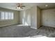 A neutral-toned bedroom that features carpeted floors and a ceiling fan at 12048 La Palmera Ave, Las Vegas, NV 89138