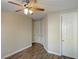 Spacious bedroom with modern ceiling fan and wood-look floors at 12048 La Palmera Ave, Las Vegas, NV 89138