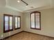 Spacious bedroom featuring wood-look floors, plantation shutters, recessed lighting, and a neutral color palette at 12048 La Palmera Ave, Las Vegas, NV 89138