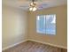 Simple bedroom with wood-look flooring and a window for natural light at 12048 La Palmera Ave, Las Vegas, NV 89138