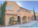 Home exterior with an elevated balcony, covered patios, and desert landscaping at 12048 La Palmera Ave, Las Vegas, NV 89138