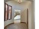 Inviting foyer with curved walls, wood-look floors, and a view of the staircase and living area at 12048 La Palmera Ave, Las Vegas, NV 89138