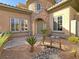 Elegant home featuring a stone turret entry, arched doorway, and bridge over a rock garden at 12048 La Palmera Ave, Las Vegas, NV 89138