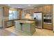 Well-lit kitchen with stainless steel appliances and a center island at 12048 La Palmera Ave, Las Vegas, NV 89138