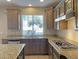 This well-equipped kitchen features granite countertops and a stainless steel dishwasher at 12048 La Palmera Ave, Las Vegas, NV 89138