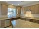 Granite countertops accent this kitchen, complete with stainless steel appliances and island at 12048 La Palmera Ave, Las Vegas, NV 89138