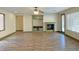 Spacious living room featuring a fireplace, built-in shelving, and wood-look flooring at 12048 La Palmera Ave, Las Vegas, NV 89138