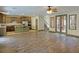 Open-concept living room showcasing wood-look flooring and staircase with access to kitchen at 12048 La Palmera Ave, Las Vegas, NV 89138