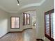 Open-concept living room with curved archway, wood-look floors, recessed lighting, and plantation shutters at 12048 La Palmera Ave, Las Vegas, NV 89138