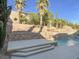 This pool features a stone accent wall, waterfall features, and mature foliage at 12048 La Palmera Ave, Las Vegas, NV 89138