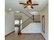 Elegant staircase with wood railings and views to adjacent rooms with plantation shutters and wood flooring at 12048 La Palmera Ave, Las Vegas, NV 89138