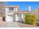 Cute two-story house with a one-car garage and landscaped front yard at 122 Boysenberry Ln, Henderson, NV 89074