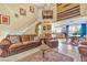 Two-story living room with leather furniture and a view of the dining area at 122 Boysenberry Ln, Henderson, NV 89074