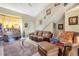 Living room with leather sofas, a piano, and access to the upper level at 122 Boysenberry Ln, Henderson, NV 89074