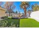 Lush backyard featuring manicured lawn, rock feature with fountain, and mature landscaping at 1245 S Rancho Dr, Las Vegas, NV 89102