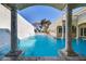 Stunning backyard pool view with archway and waterfall feature on a sunny day at 1245 S Rancho Dr, Las Vegas, NV 89102