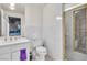 Bathroom with white fixtures, gold shower door, and a sink with vanity at 1245 S Rancho Dr, Las Vegas, NV 89102