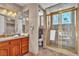 Spacious bathroom with double sink vanity, glass shower, and neutral tile flooring at 1245 S Rancho Dr, Las Vegas, NV 89102