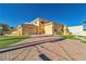 Stunning exterior view of a home with a brick driveway and manicured lawns at 1245 S Rancho Dr, Las Vegas, NV 89102