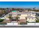 A beautiful home with an arched doorway and decorative brick driveway with palm trees at 1245 S Rancho Dr, Las Vegas, NV 89102