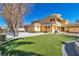 Large home with circular architectural feature, porte cochere, and manicured turf at 1245 S Rancho Dr, Las Vegas, NV 89102