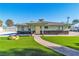 Home's front yard features a manicured lawn and desert landscaping at 1245 S Rancho Dr, Las Vegas, NV 89102