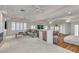 Open living room with fireplace, wet bar, tile and carpet flooring and large windows at 1245 S Rancho Dr, Las Vegas, NV 89102