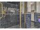 Modern tile shower featuring a glass door and gold trim and hardware at 1245 S Rancho Dr, Las Vegas, NV 89102