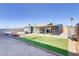 Inviting backyard with a covered patio, lush green lawn, a sitting bench, and a storage shed at 139 Ivy St, Henderson, NV 89015