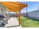 Relaxing backyard featuring a covered patio, stainless steel grill, well-maintained lawn and privacy fence at 139 Ivy St, Henderson, NV 89015