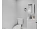 Modern half bathroom with a sleek vanity, toilet, and stylish black faucet at 139 Ivy St, Henderson, NV 89015