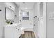 Well-lit bathroom featuring updated vanity and fixtures and shower over tub at 139 Ivy St, Henderson, NV 89015